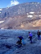 Aron, Ben, Martha get glacier melt water from the Athabasca glacier